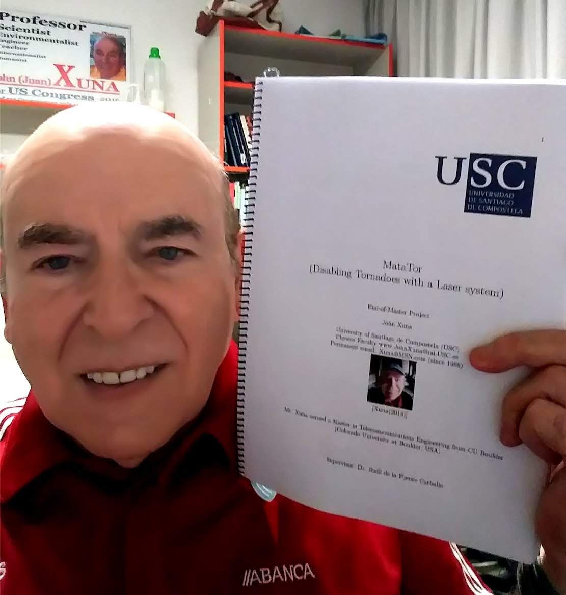 Juan Xuna holding his bound master's project from USC